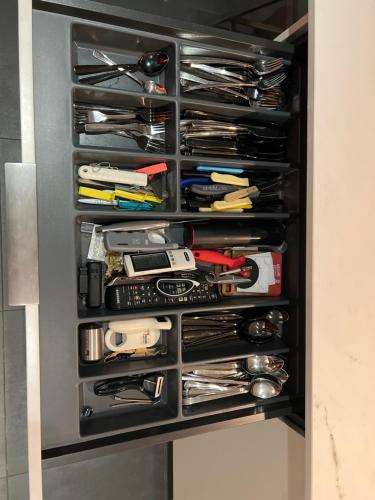 a drawer filled with lots of utensils at Suite and Room in a breathtaking new designed penthouse in SE TLV in Tel Aviv