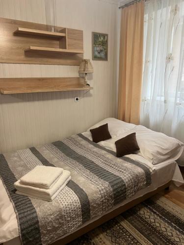 a bedroom with a bed with two towels on it at Apartament Relax in Stronie Śląskie