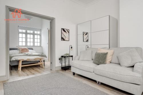 a living room with a couch and a bed at Rodney St Luxury Stays - Georgian Apartment - Centre of City in Liverpool