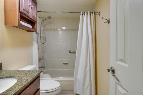 a bathroom with a toilet and a sink and a shower at Sleek Apartment in the Heart of Denver Tech Center in Englewood