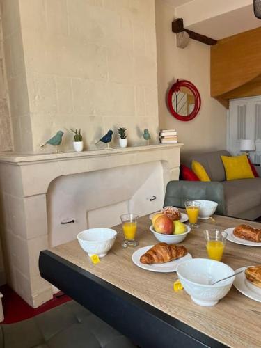 a table with bowls and plates of food on it at Le Trésor 4 pers à 20 minutes de Beauval in Montrichard