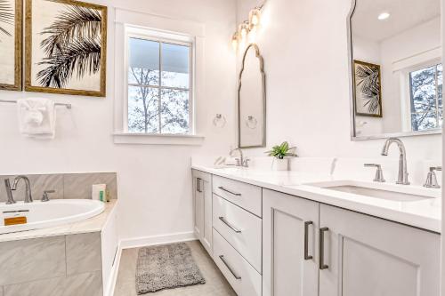 a white bathroom with two sinks and a mirror at Between the Lake and the Ocean in Santa Rosa Beach