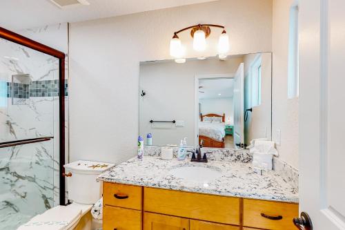 a bathroom with a sink and a mirror at Casa Capel in Port Orange