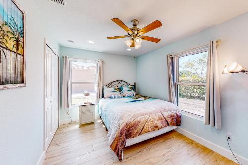 a bedroom with a bed and a ceiling fan at Casa Capel in Port Orange