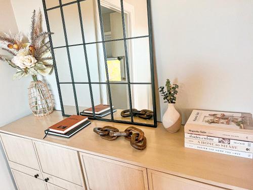 a dresser with a mirror on top of it at Cozy and Renovated 3 Bedroom Home 