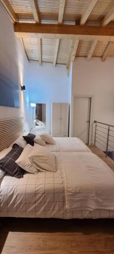 a large bed in a room with a wooden ceiling at Apartamentos Les Texuques II in Nueva de Llanes