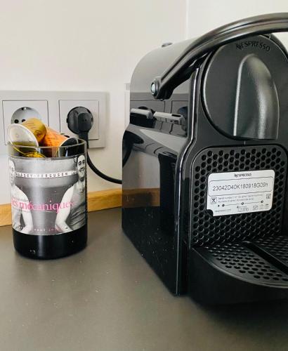 a black toaster sitting on a counter with a cup at Vintner Suites in Neustadt an der Weinstraße