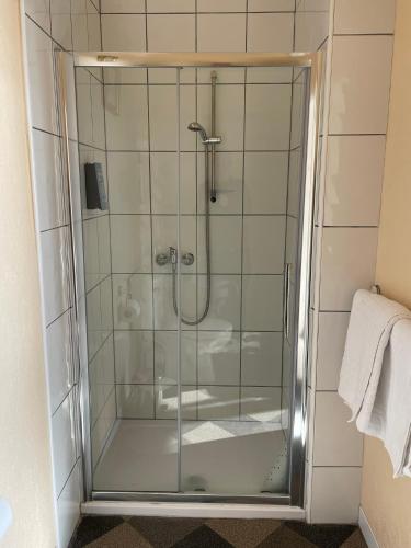 a shower with a glass door in a bathroom at The Sandbanks in Barmouth