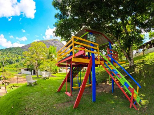 a playground with a colorful slide in a park at EcoFlat Moderno e Aconchegante in Bonito