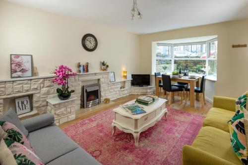 a living room with a couch and a fireplace at Ilkley Place in Ilkley