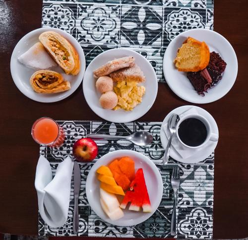 a table with plates of food and a cup of coffee at Costa Atlantico Hotel in São Luís