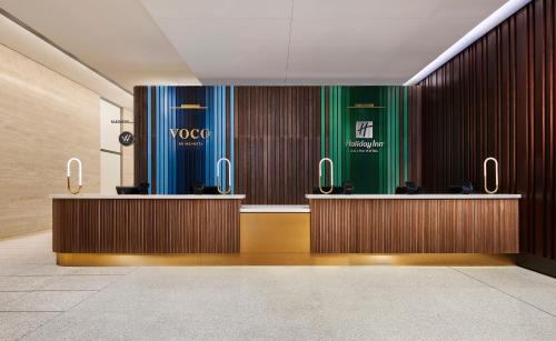 a lobby with two reception desks in a building at voco Chicago Downtown - Riverwalk by IHG in Chicago