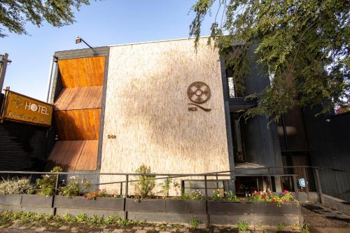 a building with a clock on the side of it at Hotel Cumbres del Sur in Pucón
