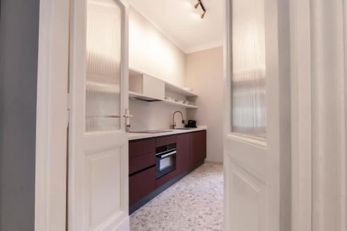 a kitchen with a white door and a sink at Be Mate Castel Sant'Angelo in Rome