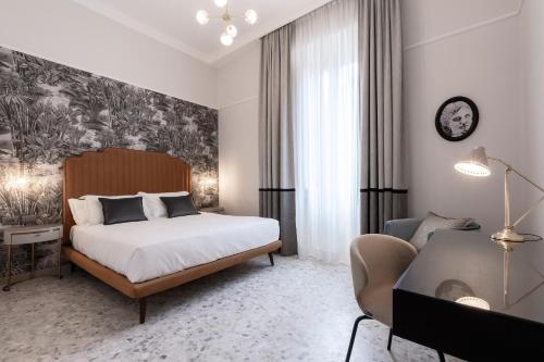 a bedroom with a bed and a desk and a couch at Be Mate Castel Sant'Angelo in Rome