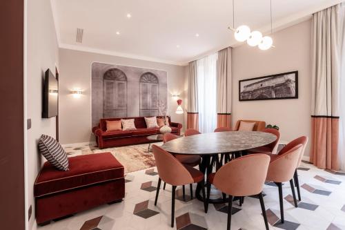 a living room with a table and chairs and a couch at Be Mate Castel Sant'Angelo in Rome