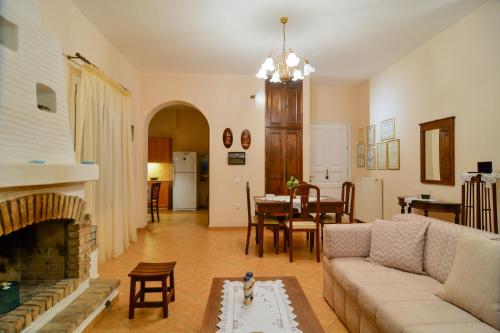 a living room with a couch and a fireplace at The Antique House in Batsi