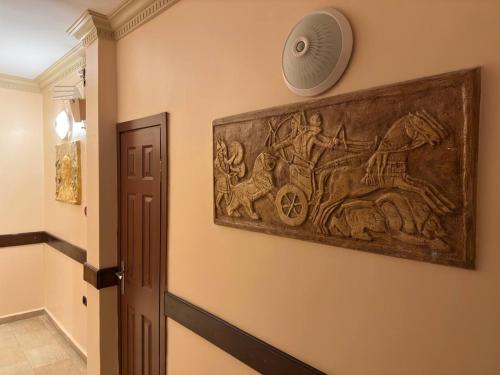 a wall with a painting of a horse pulling a cart at Hanedan Hotel in Istanbul