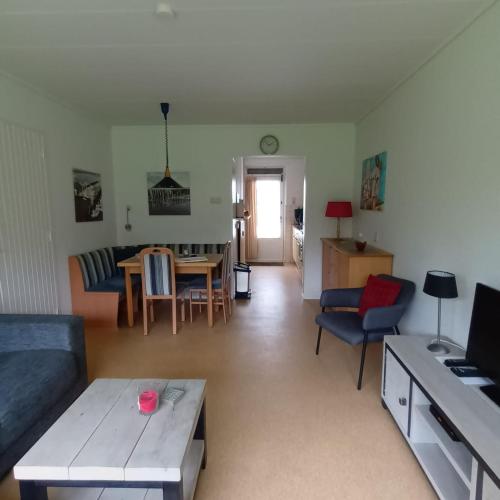 a living room with a couch and a table at Vakantiehuisje Martina 18 in Vlissingen