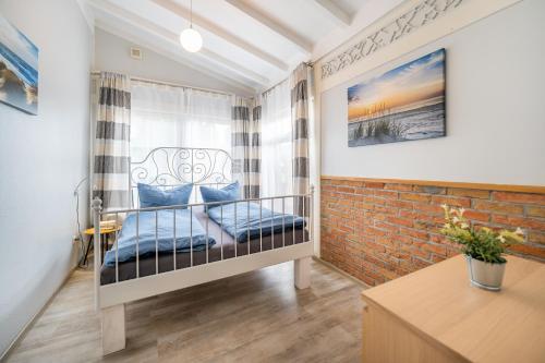 a small room with a bed and a brick wall at Haus Ferienglück Sauna im Haus in Ostseebad Sellin