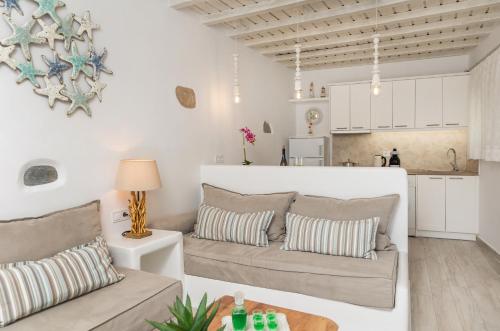 a living room with two couches and a kitchen at En Lefko boutique house in Naxos Chora