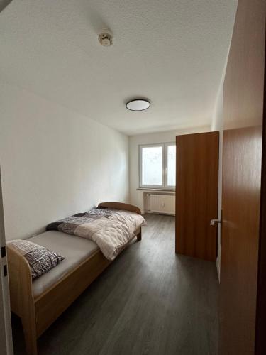 a bedroom with a bed and a window at Oberhausen Apartments in Oberhausen