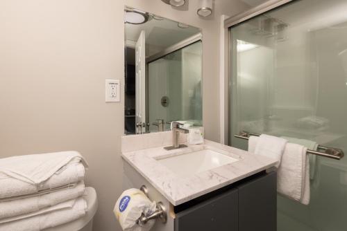 a bathroom with a sink and a mirror at Aventura on the Ocean in Myrtle Beach