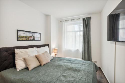 um quarto com uma cama com duas almofadas e uma janela em Altstadt Traum für 4 in Delitzsch, Parkplatz, Wifi em Delitzsch
