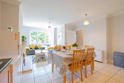 a kitchen and living room with a table and chairs at 87 - 4 Bedroom Townhouse With Parking in Galway