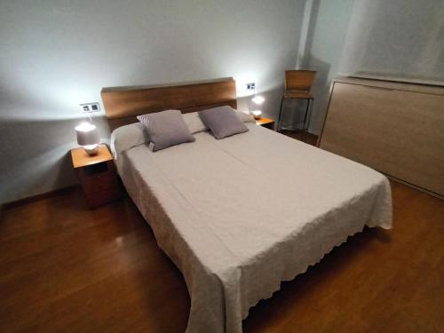 a bedroom with a large bed with two pillows on it at Apartamento playa Cambrils Torresol 2 in Cambrils