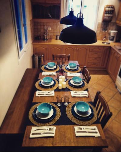 a wooden table with plates and dishes on it in a kitchen at The Antique House in Batsi