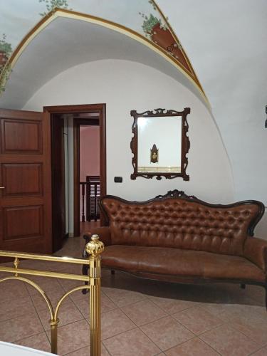 a living room with a couch and a mirror at Meraviglie Salentine in Lequile