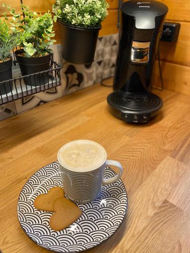 a cup of coffee and cookies on a plate on a counter at Ferienhaus-Blockhütte im Fichtelgebirge - Nagler See 2 km in Nagel