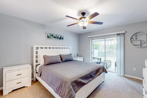 a bedroom with a bed and a ceiling fan at Santiago Lane Retreat in Bonita Springs