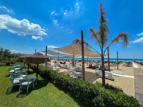 a group of chairs and umbrellas on a beach at Il Pineto Paestum Food & Rooms in Paestum