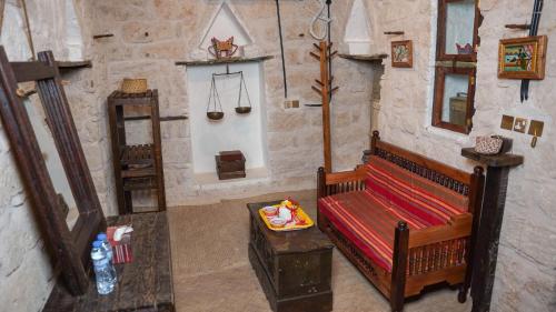 a room with a couch and a table in a building at نزل كوفان التراثي Koofan Heritage Lodge in Salalah