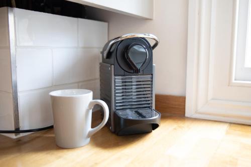 a hair dryer sitting next to a coffee cup at 35 Grosvenor Terrace - 5 min walk from York City Centre in York