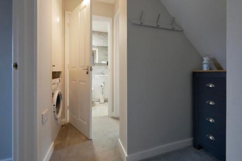 a hallway with a laundry room with a washer and dryer at Crewe Short Lets 2 Victoria Court, Crewe in Crewe