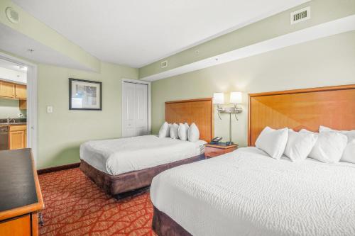 um quarto de hotel com duas camas e uma cozinha em The Splendid South Carolina Getaway em Myrtle Beach