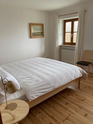 a bedroom with a large bed with a wooden floor at Watzmannkar in Bischofswiesen