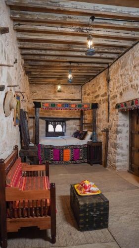 a bedroom with a bed in a stone building at نزل كوفان التراثي Koofan Heritage Lodge in Salalah
