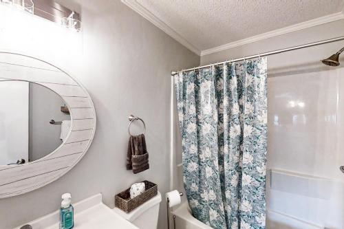 a bathroom with a shower curtain and a sink at Sea Cabin 117 in Myrtle Beach