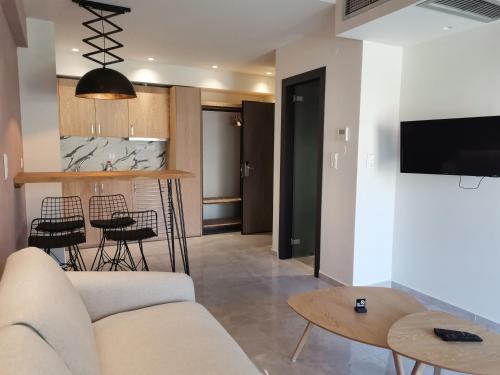 a living room with a couch and a table at Thetis Boutique Apartments in Neos Marmaras