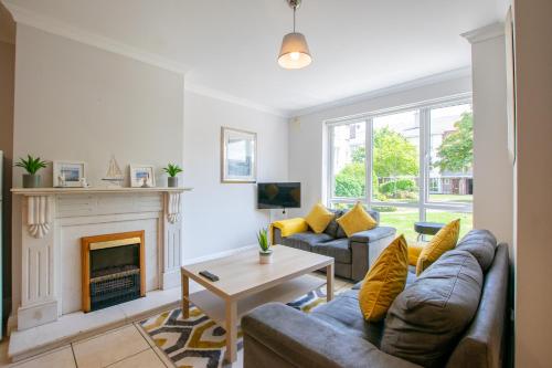 a living room with a couch and a fireplace at 87 - 4 Bedroom Townhouse With Parking in Galway