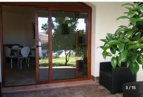a sliding glass door to a patio with a table at Relax al Mare in Olbia