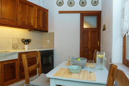a kitchen with a table with some bowls on it at Captain D - Hydra Dream Houses in Hydra