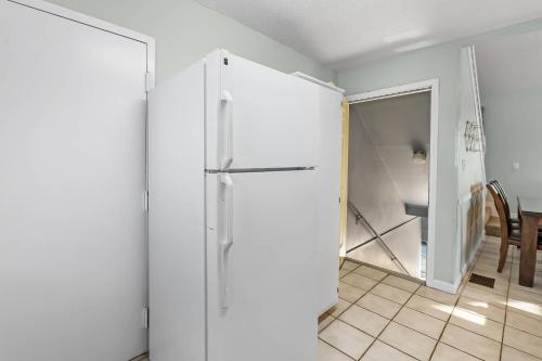 a white refrigerator in a room with a kitchen at Paradise Duplex B in Gulf Shores