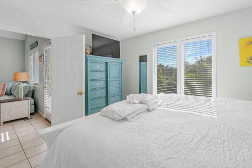 a bedroom with a bed and a blue cabinet at Paradise Duplex B in Gulf Shores