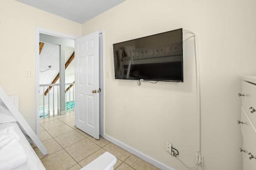 a living room with a flat screen tv on a wall at Paradise Duplex B in Gulf Shores