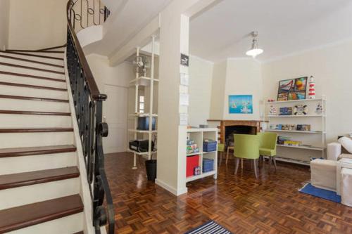 a room with a staircase and a living room at Roaz de Bandeira Guesthouse in Olhão